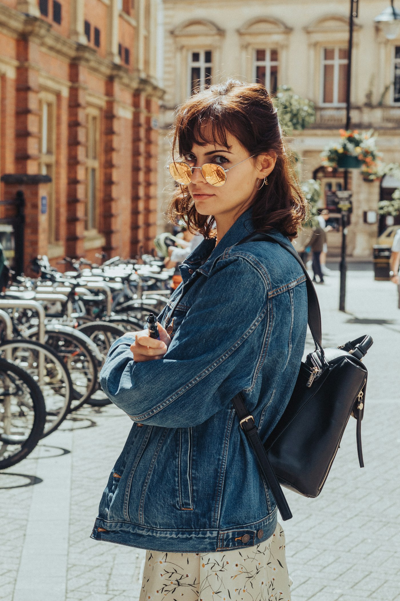 Woman wearing an oversized blue denim jacket on a street